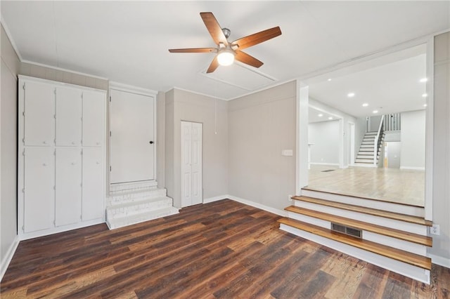 interior space with ceiling fan and dark hardwood / wood-style flooring