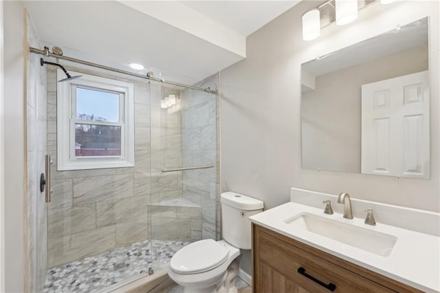 bathroom with vanity, toilet, and an enclosed shower