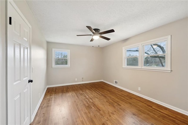 unfurnished bedroom featuring ceiling fan, a textured ceiling, and hardwood / wood-style flooring