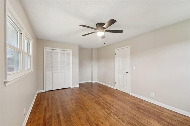 unfurnished bedroom featuring a closet, ceiling fan, and hardwood / wood-style floors