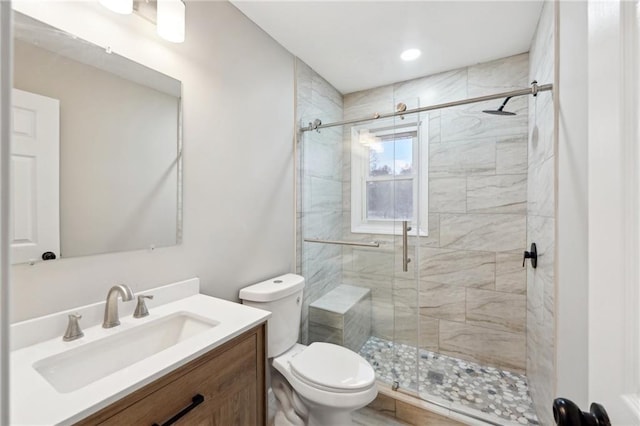 bathroom with vanity, toilet, and walk in shower