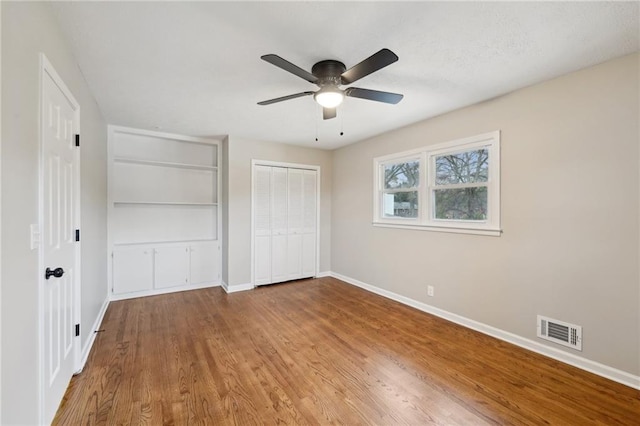 unfurnished bedroom featuring ceiling fan and hardwood / wood-style floors