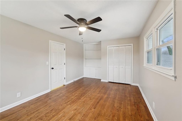 unfurnished bedroom with ceiling fan and wood-type flooring