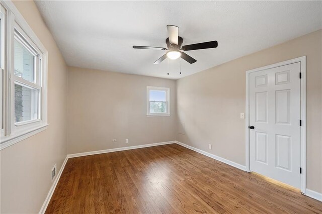 unfurnished room featuring ceiling fan and hardwood / wood-style floors