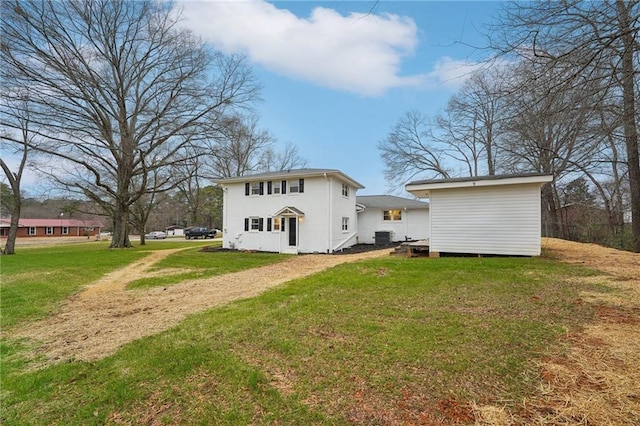 rear view of house featuring a lawn