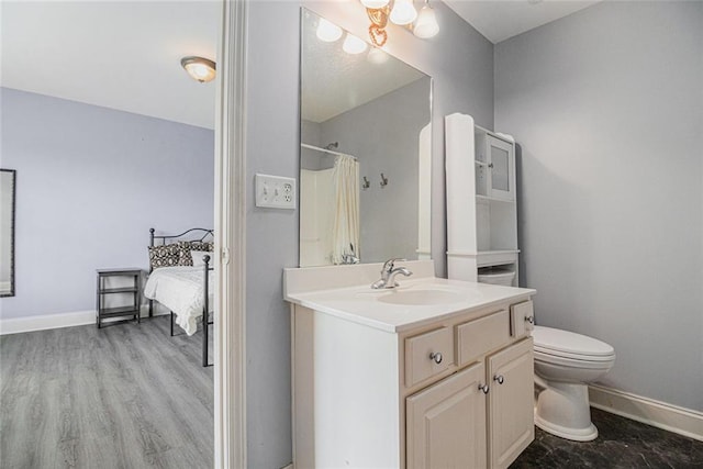 full bathroom featuring baseboards, toilet, vanity, curtained shower, and connected bathroom