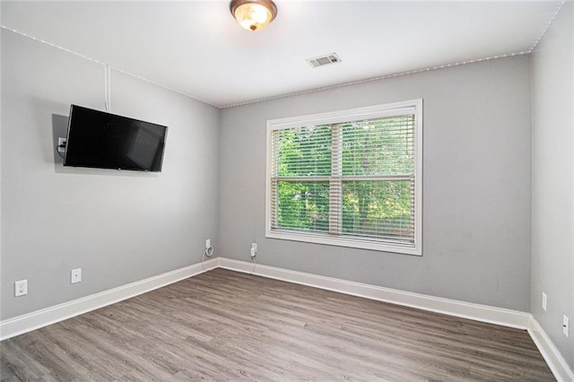 unfurnished room featuring wood finished floors and baseboards