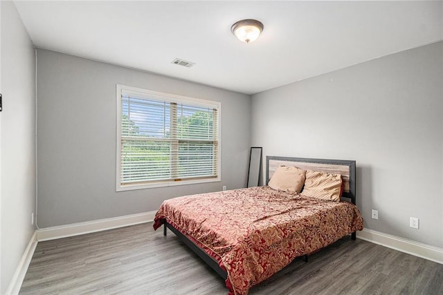 bedroom featuring wood finished floors and baseboards
