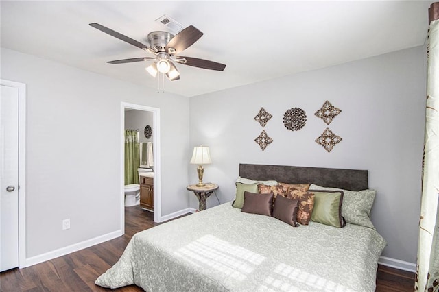 bedroom featuring ensuite bathroom, dark hardwood / wood-style floors, and ceiling fan