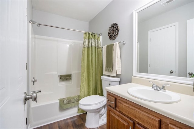 full bathroom featuring hardwood / wood-style flooring, vanity, toilet, and shower / bath combo