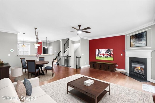 5748 Pine Oak Dr NW, Norcross, GA 30092 - living room with wood finished floors, stairs, and crown molding