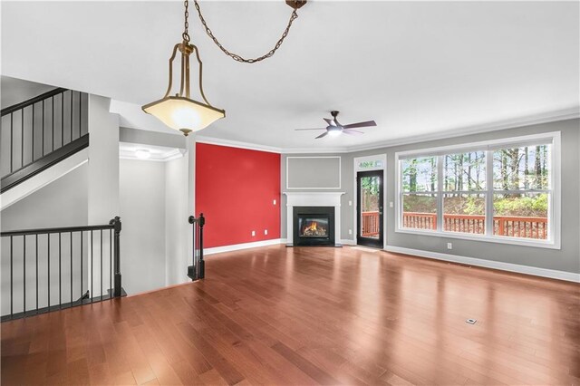 5748 Pine Oak Dr NW, Norcross, GA 30092 - unfurnished living room with wood finished floors, a ceiling fan, ornamental molding, and a glass covered fireplace