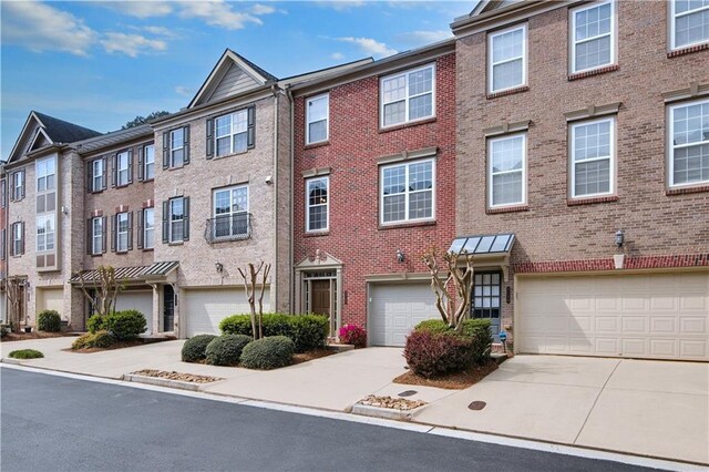 5748 Pine Oak Dr NW, Norcross, GA 30092 - view of property with driveway, brick siding, and a garage