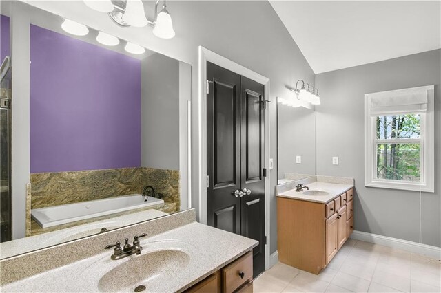 5748 Pine Oak Dr NW, Norcross, GA 30092 - full bath featuring tile patterned flooring, a bath, vanity, baseboards, and lofted ceiling
