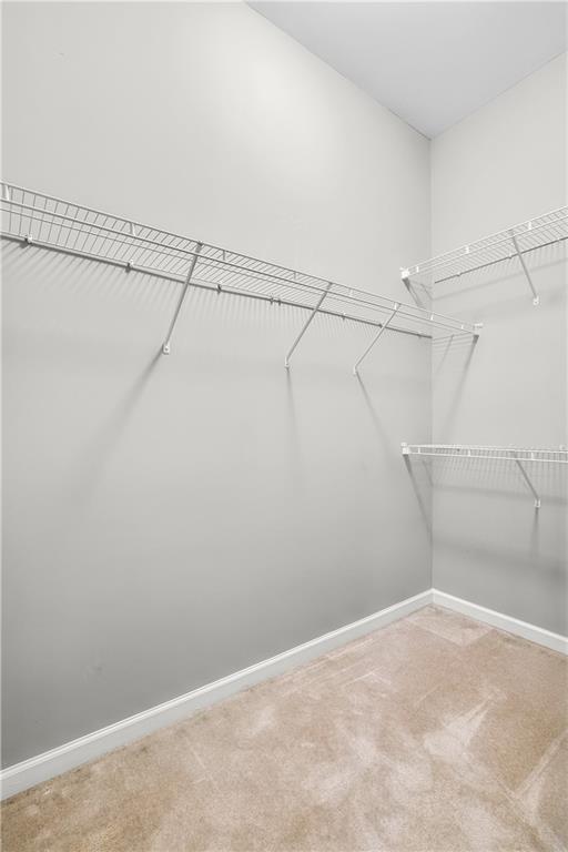 5748 Pine Oak Dr NW, Norcross, GA 30092 - walk in closet featuring carpet floors