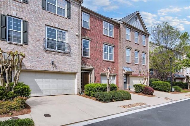 5748 Pine Oak Dr NW, Norcross, GA 30092 - view of front of home with concrete driveway, an attached garage, and brick siding