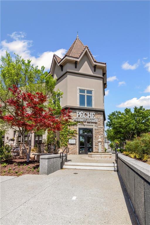 5748 Pine Oak Dr NW, Norcross, GA 30092 - view of front facade featuring stucco siding, french doors, and stone siding