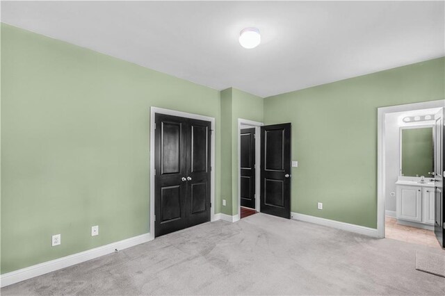 5748 Pine Oak Dr NW, Norcross, GA 30092 - unfurnished bedroom with baseboards, carpet floors, and connected bathroom