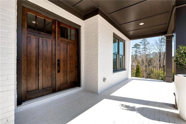 entrance to property featuring brick siding