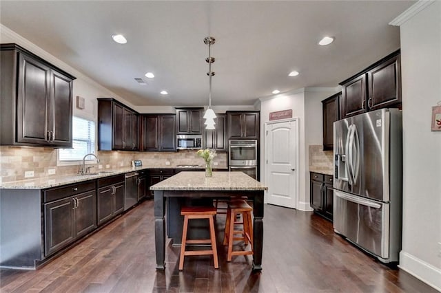 4191 Secret Shoals Way, Buford, GA 30518 - kitchen with stainless steel appliances, ornamental molding, a center island, a sink, and dark brown cabinets