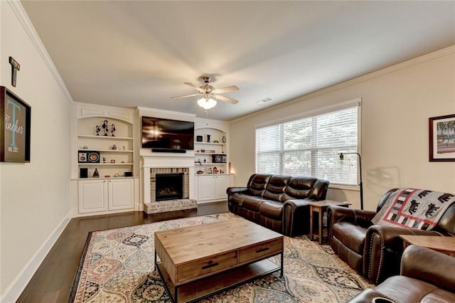 4191 Secret Shoals Way, Buford, GA 30518 - living room with ornamental molding, a ceiling fan, dark wood-type flooring, baseboards, and a fireplace