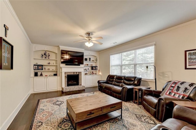4191 Secret Shoals Way, Buford, GA 30518 - living room with crown molding, a ceiling fan, dark wood finished floors, a brick fireplace, and built in shelves