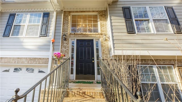 view of exterior entry with a garage