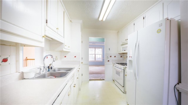 kitchen with white cabinetry, white appliances, sink, and a textured ceiling