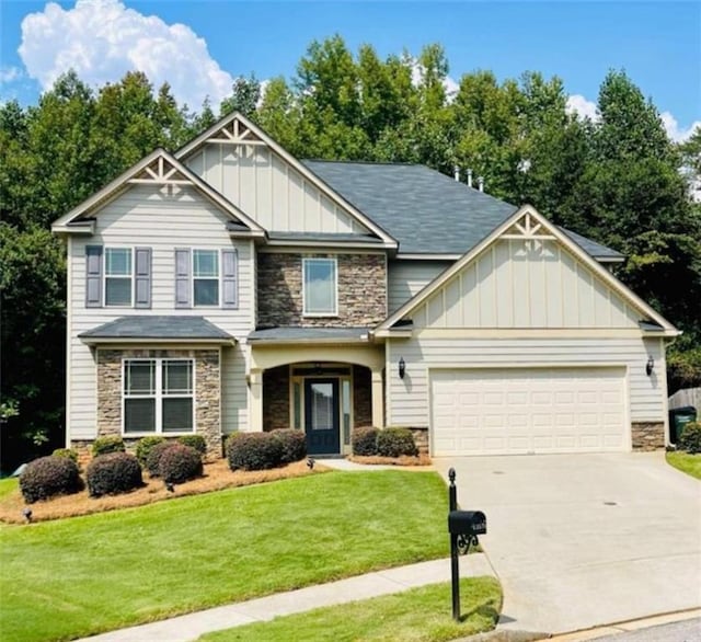 craftsman-style house featuring concrete driveway, an attached garage, board and batten siding, stone siding, and a front lawn