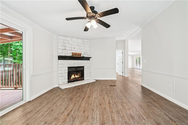 6670 George Ct, Cumming, GA 30041 - unfurnished living room with wood finished floors, a ceiling fan, a fireplace, and ornamental molding