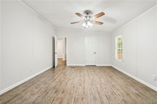 6670 George Ct, Cumming, GA 30041 - empty room featuring a textured ceiling, a ceiling fan, crown molding, wood finished floors, and baseboards