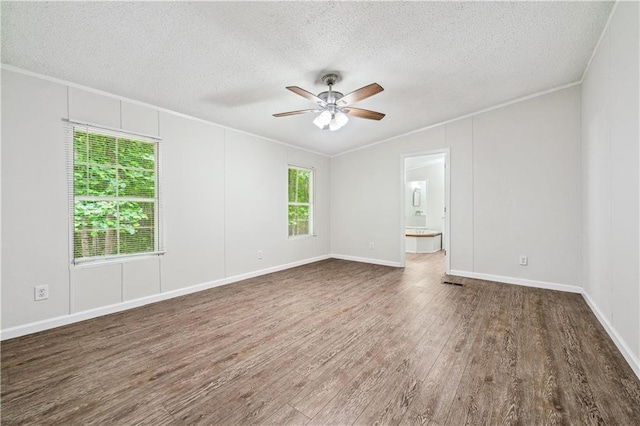 6670 George Ct, Cumming, GA 30041 - empty room featuring a textured ceiling, a ceiling fan, crown molding, wood finished floors, and baseboards