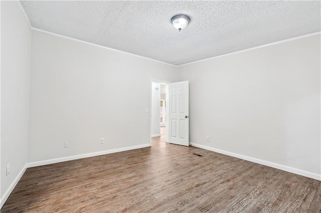 6670 George Ct, Cumming, GA 30041 - empty room featuring a textured ceiling, wood finished floors, ornamental molding, and baseboards