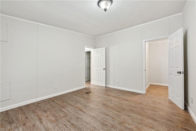 6670 George Ct, Cumming, GA 30041 - unfurnished bedroom featuring a textured ceiling, wood finished floors, and ornamental molding
