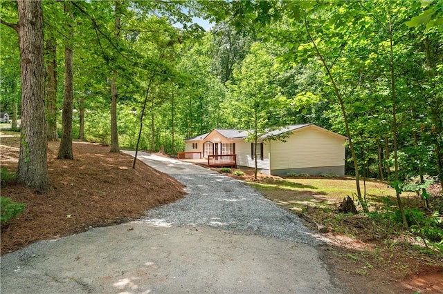 6670 George Ct, Cumming, GA 30041 - single story home featuring a forest view and driveway