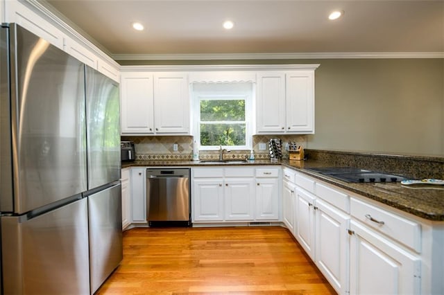 1304 Carrington Way, Lawrenceville, GA 30044 - kitchen featuring stainless steel appliances, ornamental molding, a sink, white cabinetry, and light wood-type flooring