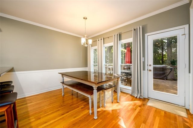 1304 Carrington Way, Lawrenceville, GA 30044 - dining space with a chandelier, ornamental molding, light wood-type flooring, and a wainscoted wall