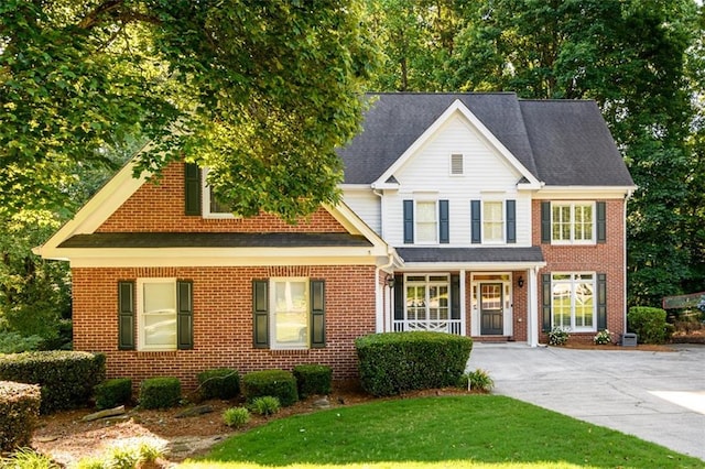 1304 Carrington Way, Lawrenceville, GA 30044 - view of front of home with brick siding, covered porch, concrete driveway, and a front lawn