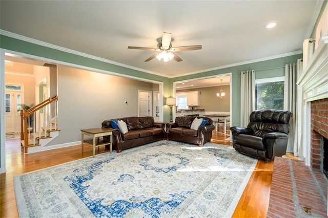 1304 Carrington Way, Lawrenceville, GA 30044 - living area with ceiling fan, wood finished floors, stairs, a brick fireplace, and crown molding