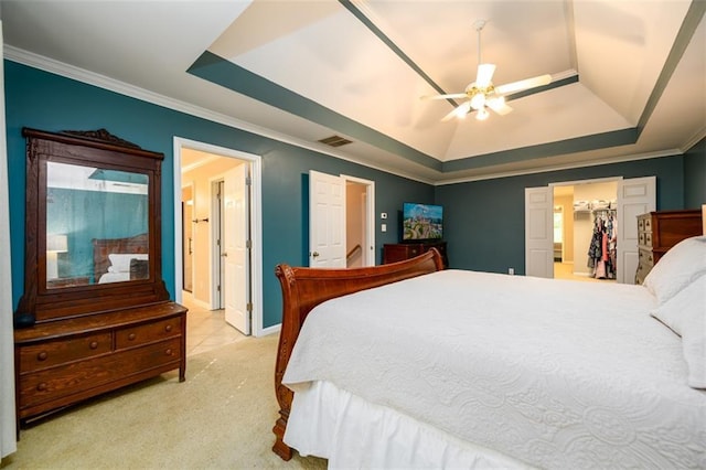 1304 Carrington Way, Lawrenceville, GA 30044 - bedroom with a raised ceiling, crown molding, light colored carpet, a walk in closet, and a ceiling fan