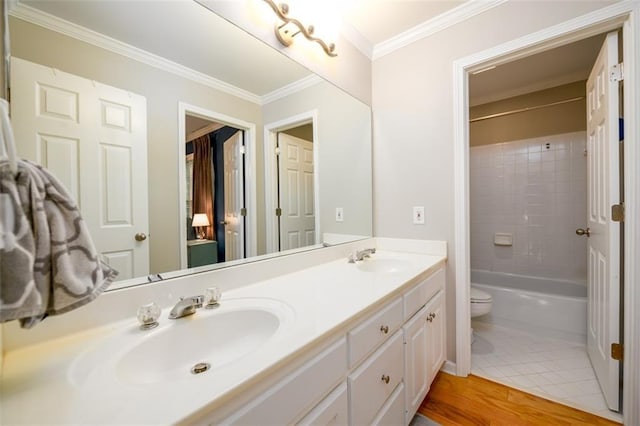 1304 Carrington Way, Lawrenceville, GA 30044 - full bath with double vanity, toilet, ornamental molding, shower / tub combination, and wood finished floors