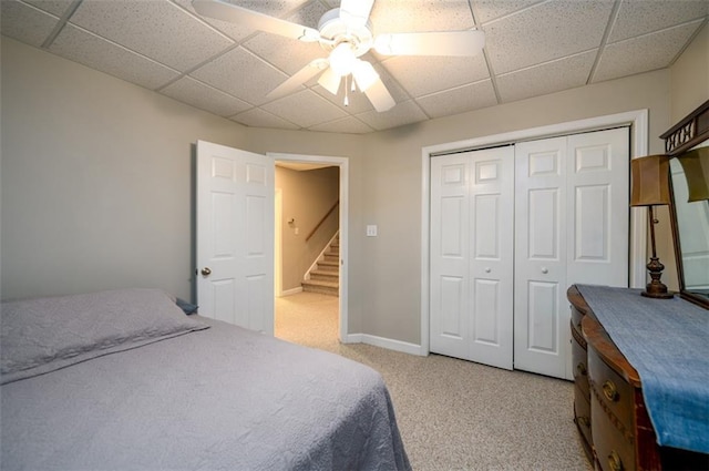 1304 Carrington Way, Lawrenceville, GA 30044 - bedroom with a drop ceiling, light colored carpet, a closet, a ceiling fan, and baseboards