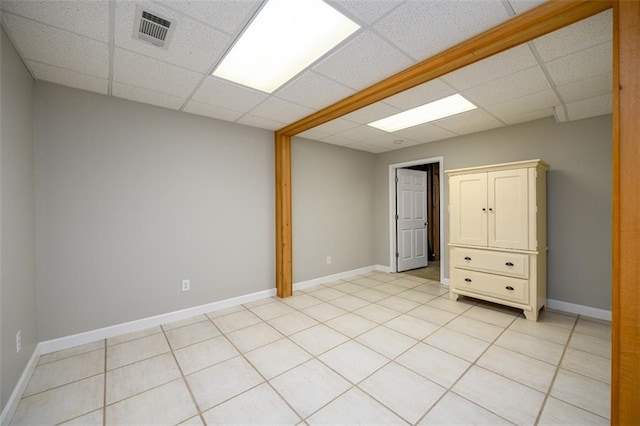 1304 Carrington Way, Lawrenceville, GA 30044 - unfurnished bedroom featuring a paneled ceiling, baseboards, and light tile patterned flooring