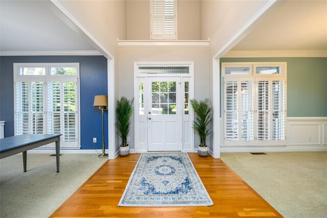 1304 Carrington Way, Lawrenceville, GA 30044 - entrance foyer with healthy amount of natural light, a high ceiling, ornamental molding, baseboards, and wood finished floors