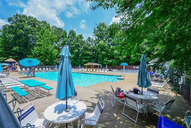 1304 Carrington Way, Lawrenceville, GA 30044 - community pool with a patio and view of wooded area