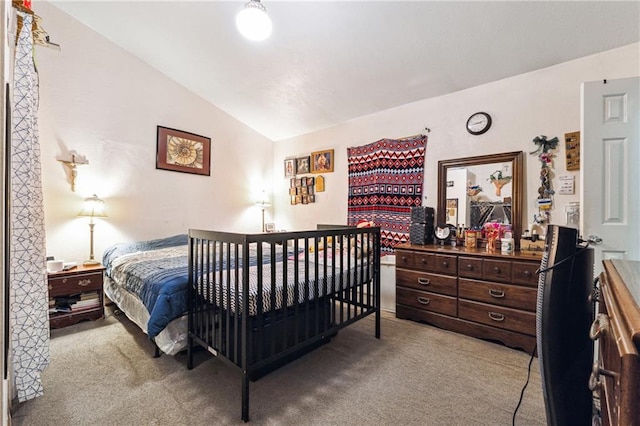bedroom with carpet floors and lofted ceiling
