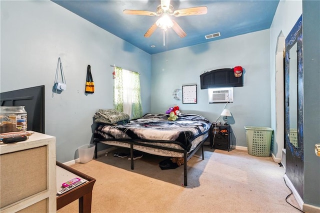 bedroom with visible vents, baseboards, ceiling fan, an AC wall unit, and carpet flooring