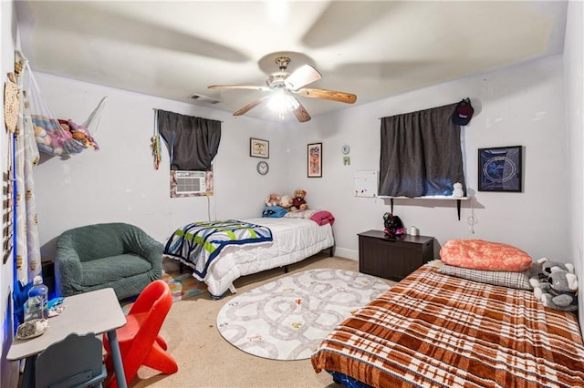 bedroom with cooling unit, a ceiling fan, carpet flooring, and visible vents