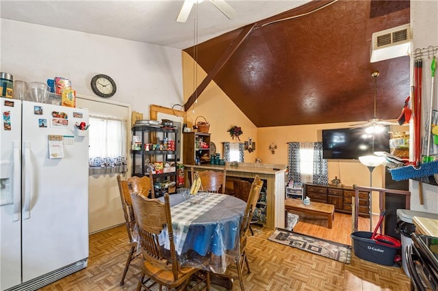dining area with a ceiling fan, lofted ceiling, and visible vents