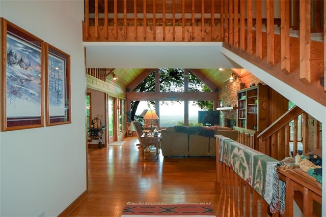 1115 Wild Turkey Blf, Jasper, GA 30143 - interior space with high vaulted ceiling, wood finished floors, beam ceiling, and a fireplace